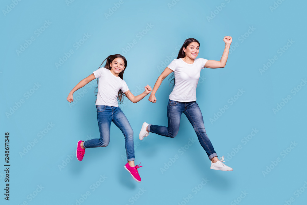 Full length body size profile side view of two nice crazy lovely attractive cheerful funny slim sporty people in white t-shirt having fun rush hour isolated over blue pastel background Full length body size profile side view of two nice crazy lovely attractive cheerful funny slim sporty people in white t-shirt having fun rush hour isolated over blue pastel background