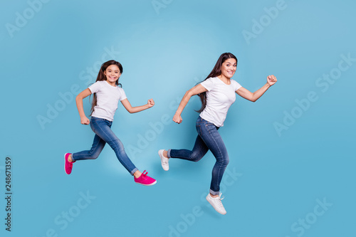 Full length body size profile side view of two nice crazy sweet lovely attractive cheerful funny slim people in white t-shirt jeans denim rush hour isolated over blue pastel background