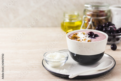 Healthy breakfast  cherry smoothie with granola  honey and coconut flakes. Selective focus  space for text.