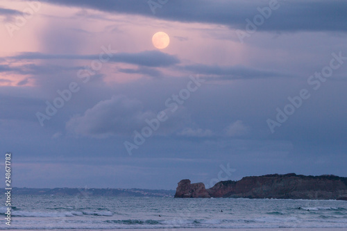 Hendaia's beach with full moon before eclypse at the Basque Country photo