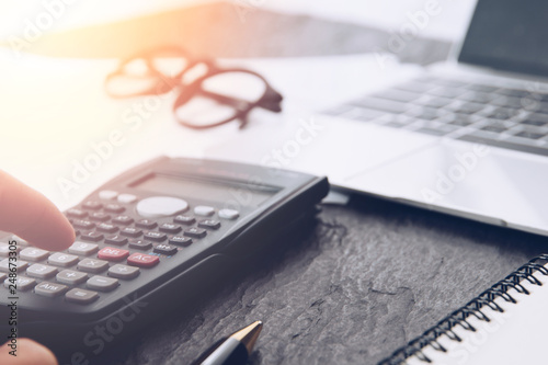 Financial accounting analysis Close up of hand counting on calculator in office desk