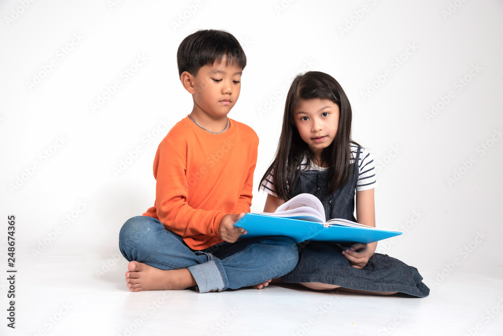 Two children siit and reading book at school,fun and happy,education concept,learning and knowlage.white background. Two children siit and reading book at school,fun and happy,education concept,learning and knowlage.white background.