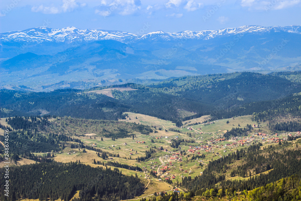 Lovely fairytale valley with a typical Ukrainian village among the majestic green Carpathians