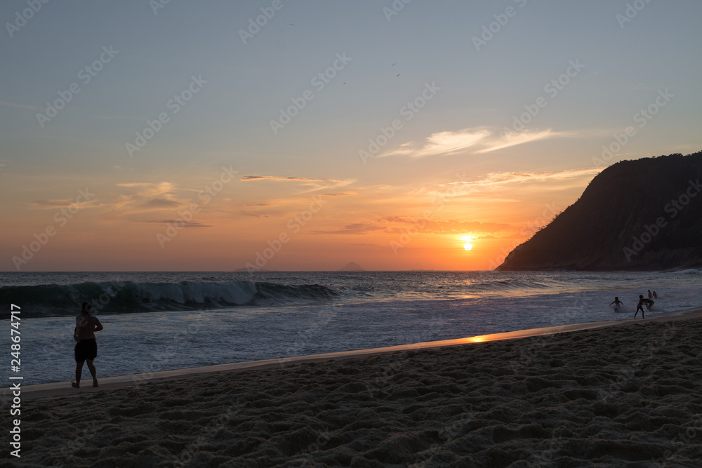 beautiful sunset on the beach of itacoatiara in niterói, rio de janeiro, brazil