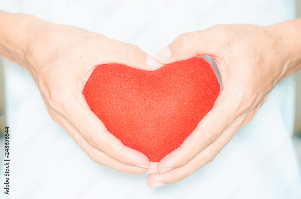 handsome man holding red heart in hands and making heart shape gesture sign body language giving for love life healthy care medicine hospital concept and lovely romantic for valentines day. handsome man holding red heart in hands and making heart shape gesture sign body language giving for love life healthy care medicine hospital concept and lovely romantic for valentines day.