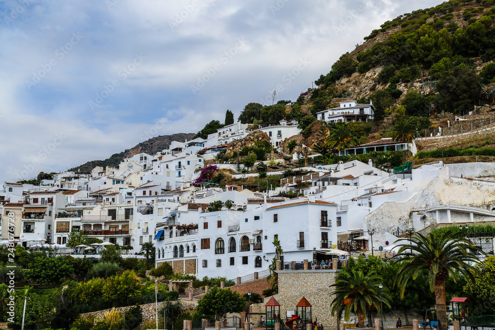 Typical white mediterrean houses climbing up a hill in a beatiful landscape