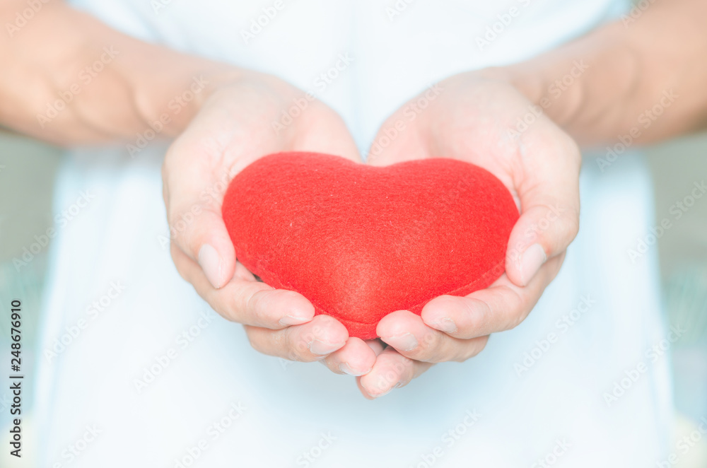 handsome man holding red heart in hands giving for love life healthy care medicine hospital concept and lovely romantic for valentines day. handsome man holding red heart in hands giving for love life healthy care medicine hospital concept and lovely romantic for valentines day.