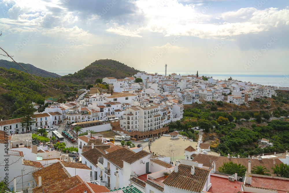 Naklejka premium Unique view of the rooftops in Frigiliana with white houses the green mountain and the sea at the horizon