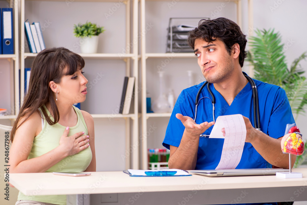 Fototapeta premium Young patient visiting doctor cardiologist