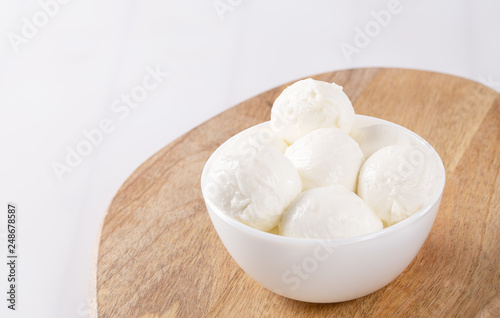 Fresh mozzarella in a bowl on white background