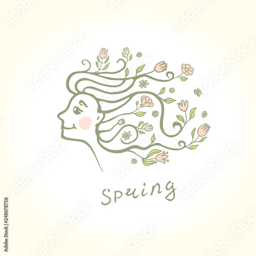 Profile of a beautiful girl with flowers in her hair. Spring flower hairstyle.