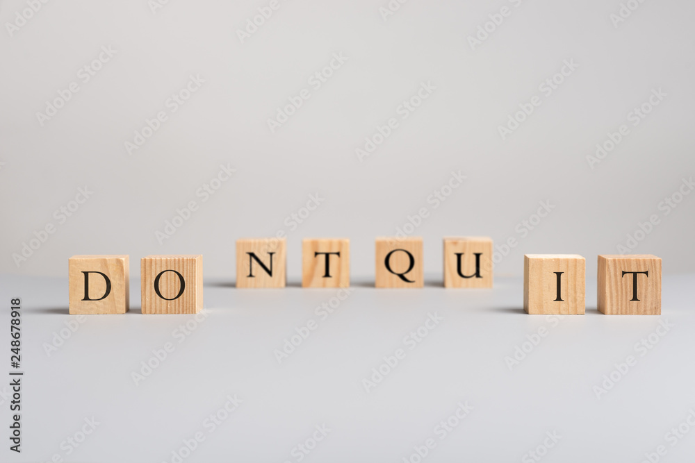 Wooden blocks with letters spelling dont quit Wooden blocks with letters spelling dont quit