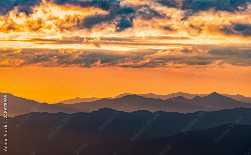 Dramatic clouds with mountain and sunset sky