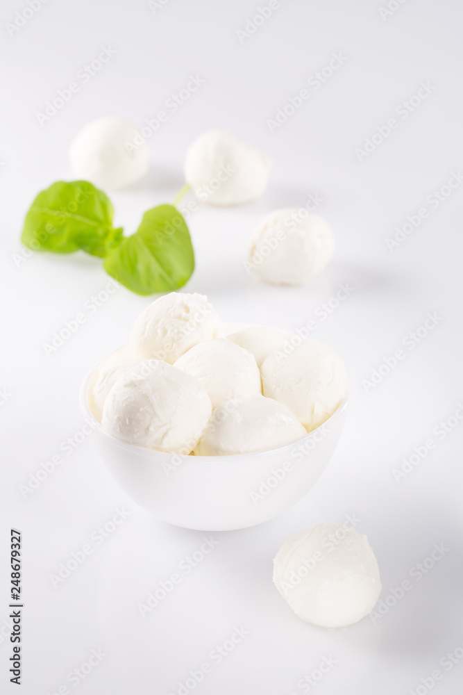 Fresh mozzarella in a bowl on white background Fresh mozzarella in a bowl on white background