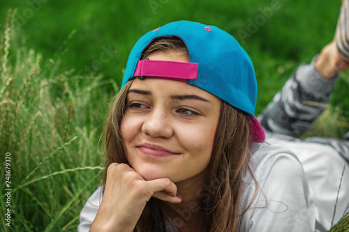 A beautiful teen girl in a baseball cap 