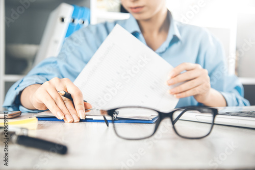 woman hand document with glasses on desk