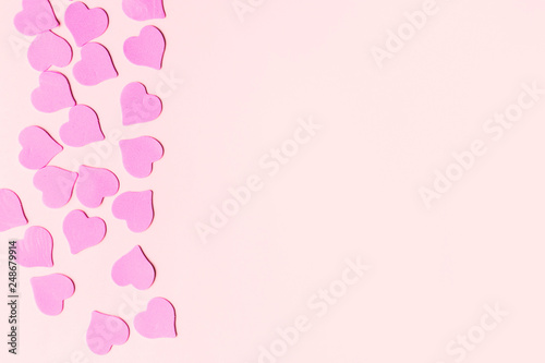 Pastel colored background with pink hearts with copy space for text. Valentine Day. © liliyabatyrova