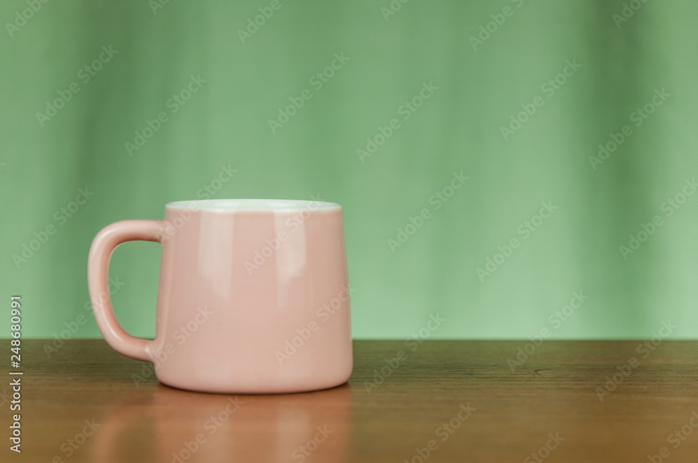 pink coffee cup on old wooden table