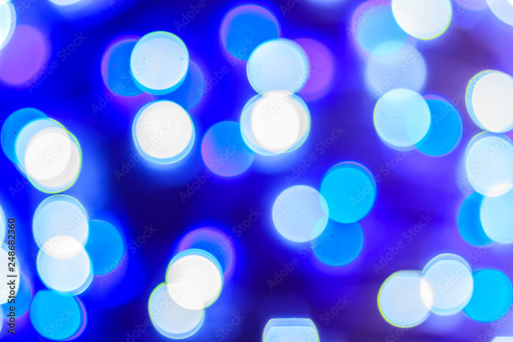 Beautiful blue bokeh abstract light background. Wonderful Defocused abstract blue christmas background. Abstract christmas lights as background in the night with noise grain and poor light. Beautiful blue bokeh abstract light background. Wonderful Defocused abstract blue christmas background. Abstract christmas lights as background in the night with noise grain and poor light.