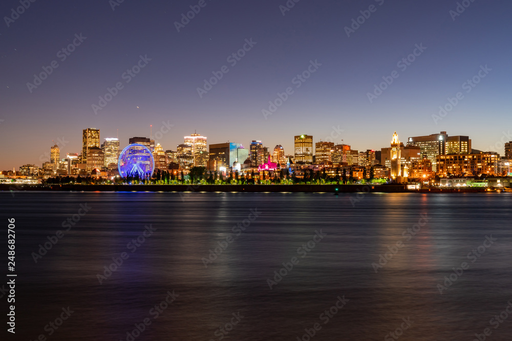 Obraz premium Night view of the Montreal city skyline with St Lawrence river