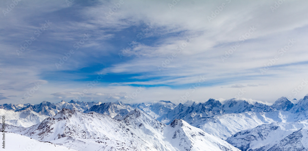 Snowy Mountains in blue and white sky