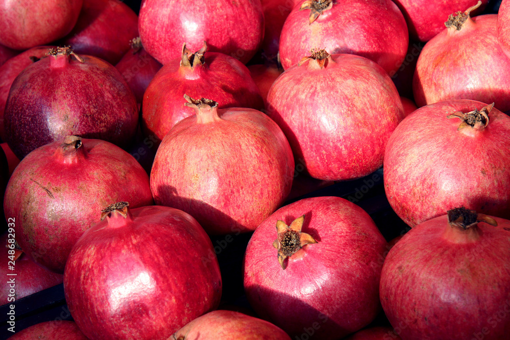 Rows Of Pomegranates. Pomegranate Closeup, Background. Group Of Ripe Pomegranates Rows Of Pomegranates. Pomegranate Closeup, Background. Group Of Ripe Pomegranates