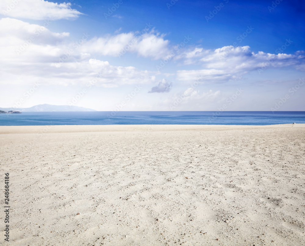 Obraz premium Beach background of yellow sand and sea landscape with blue sky. Free space for your decoration. 
