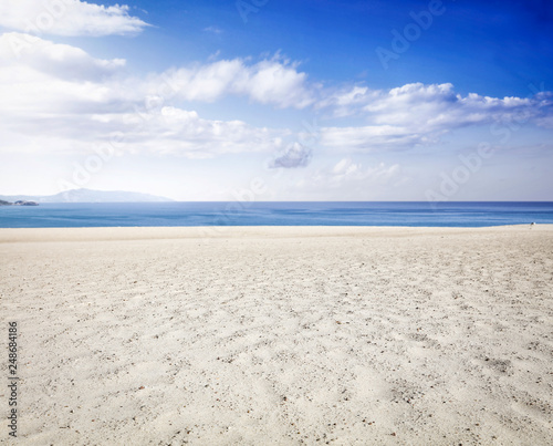 Beach background of yellow sand and sea landscape with blue sky. Free space for your decoration. 