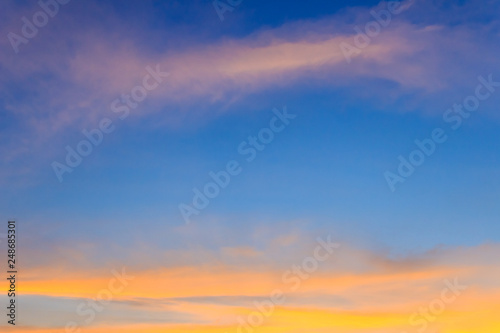 Beautiful red, orange and yellow clouds and blue sky background. Colorful exotic sky with orange clouds and blue sky on background