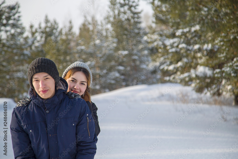 young couple walking in winter park