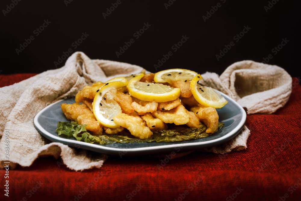 Chinese food fried fish and lemon slices