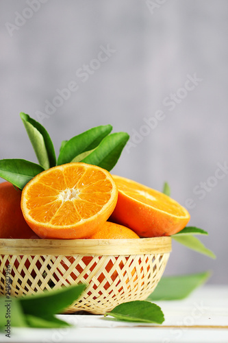 Fototapeta Naklejka Na Ścianę i Meble -  Fresh oranges fruit in basket on white table background.