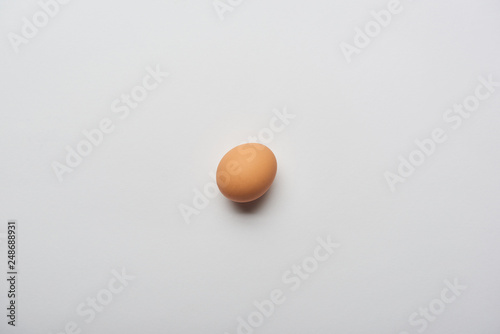 top view of organic brown egg on grey background