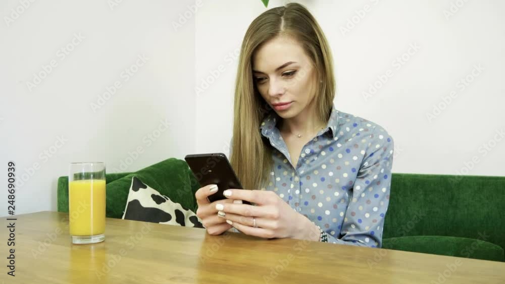 Attractive young happy woman using mobile phone during resting in a cafe. 4K Attractive young happy woman using mobile phone during resting in a cafe. 4K