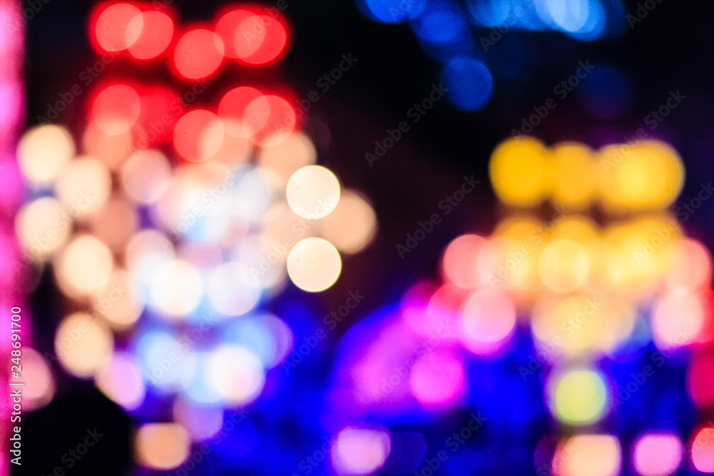 Beautiful blue bokeh abstract light background. Wonderful Defocused abstract blue christmas background. Abstract christmas lights as background in the night with noise grain and poor light.