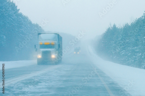 trucks on the road in a snow storm