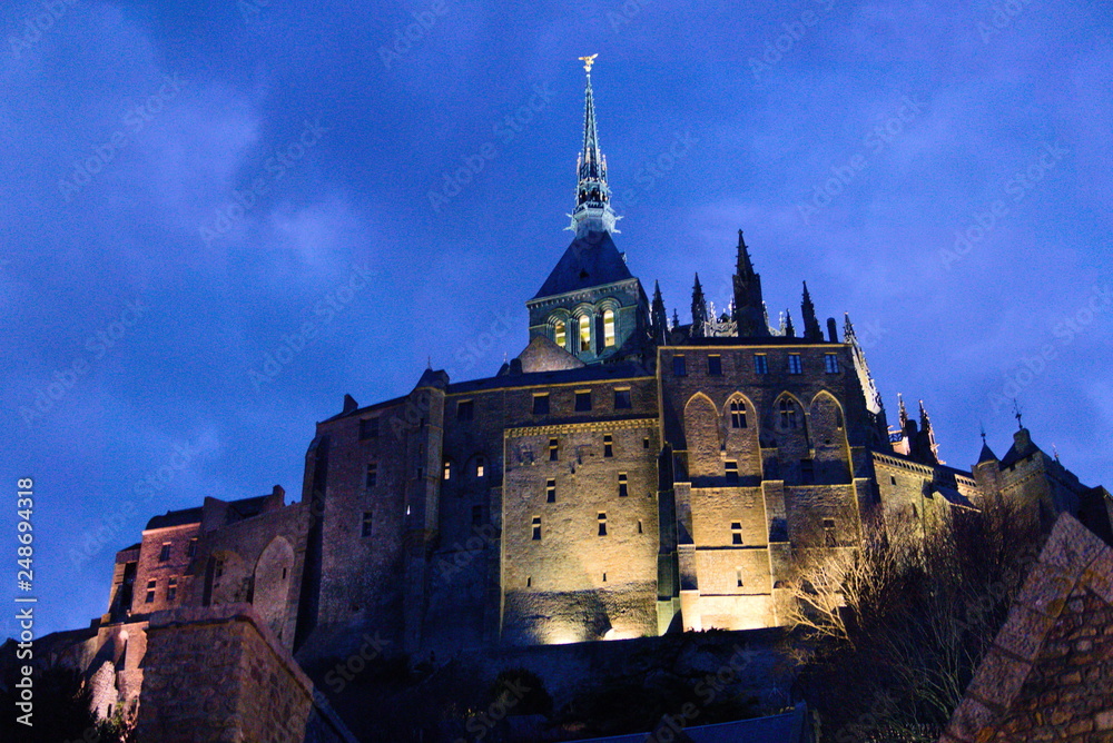 Mont saint michel monastery at night lit from beneath sunset spooky gothic