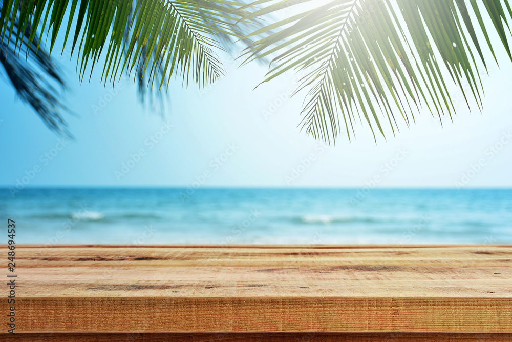 Tropical beach background with palm tree and empty wooden, Summer.