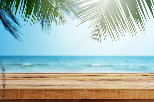 Tropical beach background with palm tree and empty wooden  Summer.