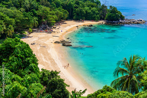 Tropical Laem Sing beach. Beautiful turquoise bay and people relaxing on beach. Paradise coast of Phuket, Thailand.