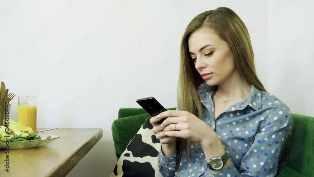 Attractive young happy woman using mobile phone during resting in a cafe. 4K Attractive young happy woman using mobile phone during resting in a cafe. 4K
