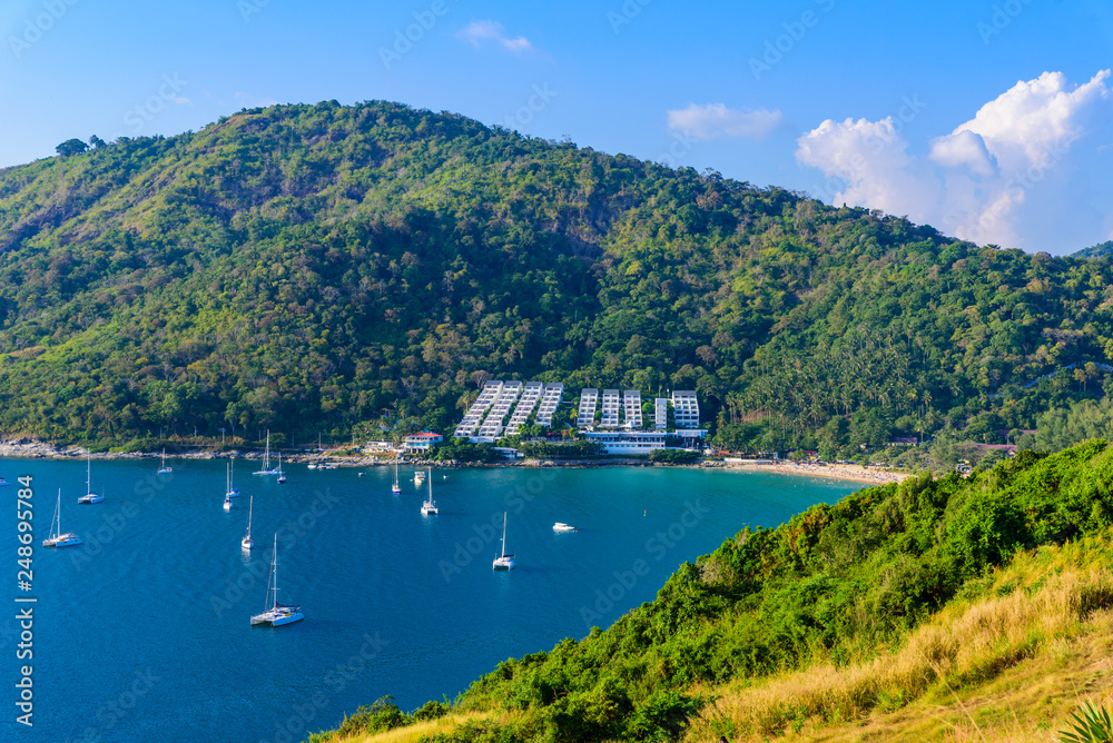 Tropical bay at Naiharn and Ao Sane beach with boats at windmill viewpoint, Paradise destination Phuket, Thailand