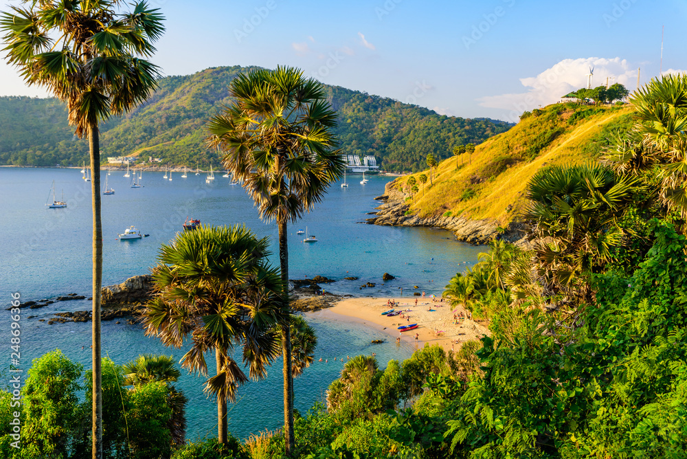 Yanui Beach is a paradise cove located between Nai Harn Beach and Promthep Cape in Phuket, Thailand. On a sunny summer day at sunset.