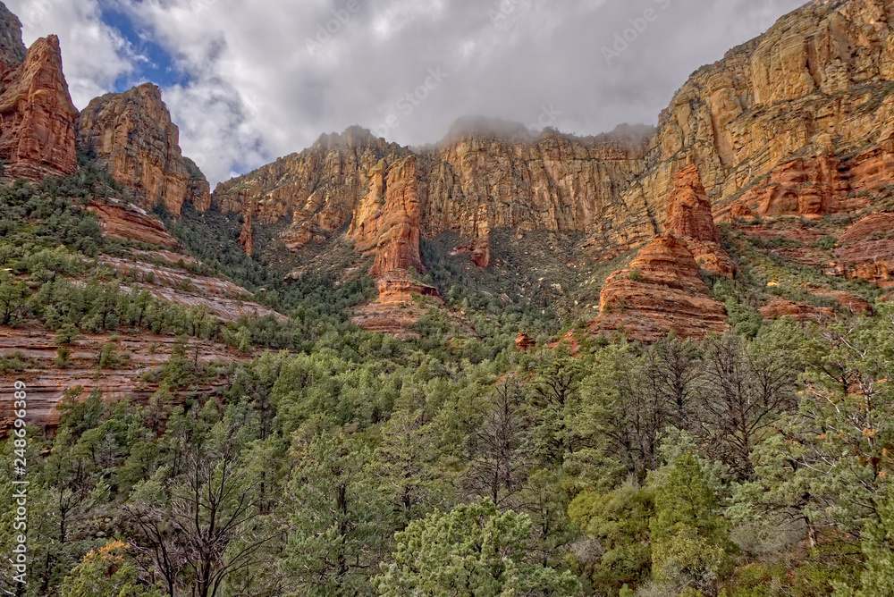Cliffs of Wilson Canyon Sedona AZ. Clouds rolling in across the high cliffs at the end of the box canyon known as Wilson Canyon in Sedona Arizona.