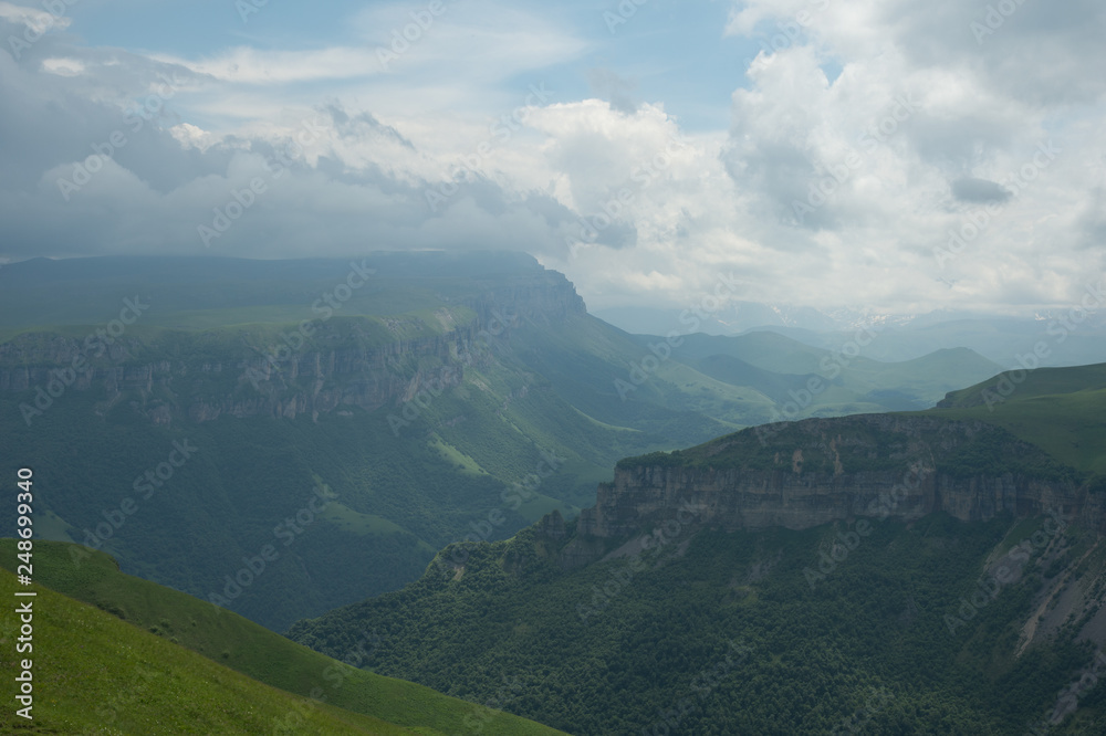 Dramatic landscape of a green valley at the foot of the Inal Plateau in the North Caucasus