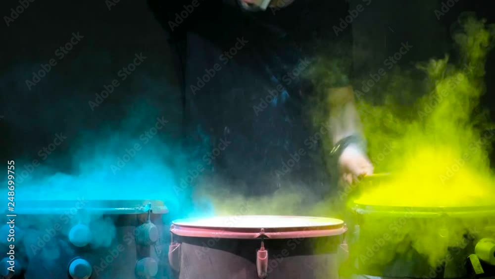 Holi powder bounces off the drum in the form of a shock wave, Close up. Black background