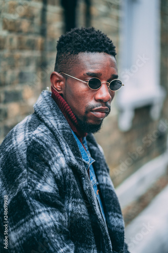Young fashionable man posing for stylish urban photo shoot 