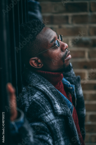 Young fashionable man posing for stylish urban photo shoot 