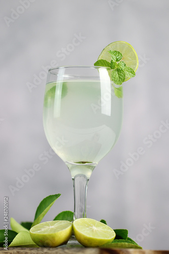 Lime juice, limes slice with mint leaves on table, Fresh drink lemonade.