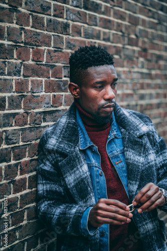 Young fashionable man posing for stylish urban photo shoot 